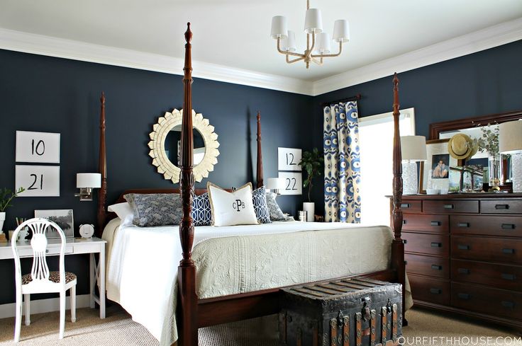 blue and white bedroom with dark furniture