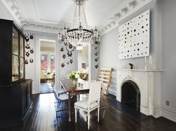 antlers on walls dark wooden floorboards dining room with fireplace