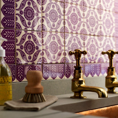 brass faucets with purple Moroccan tiles