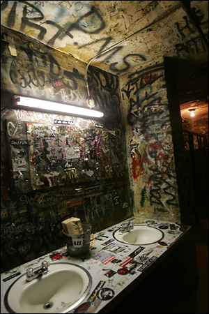 bathroom covered in graffiti