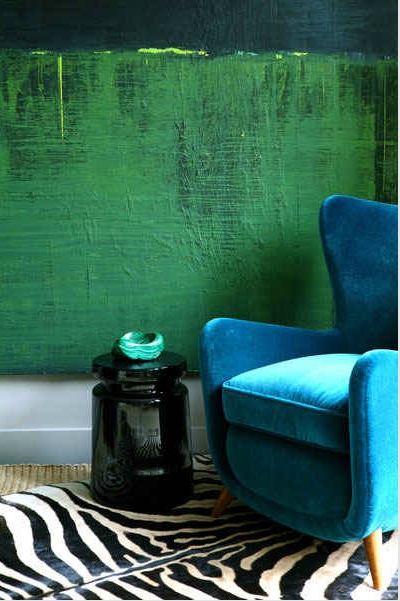 blue velvet chair and green wall