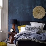 deep blue accent wall in modern eclectic bedroom